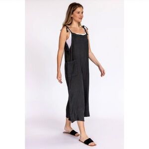 Nati black linen jumpsuit with tie shoulders and pockets